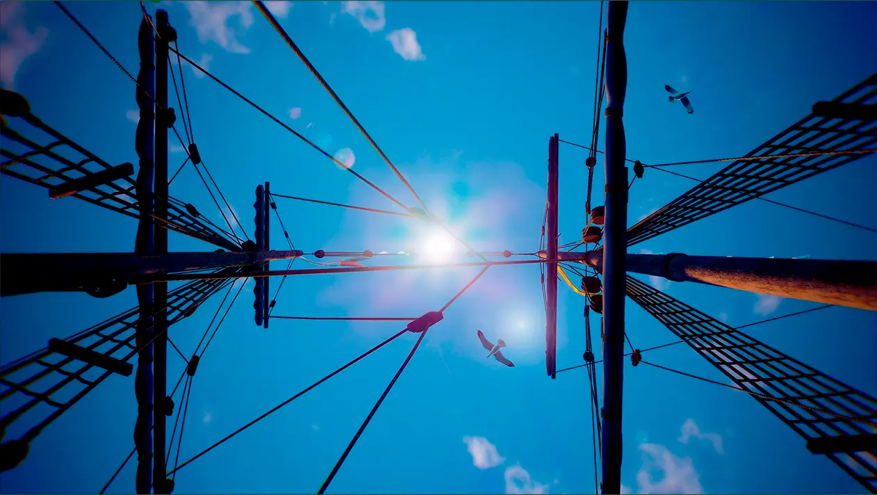 Vista desde la cubierta de la Nao Victoria hacia los mástiles, mostrando el cielo azul, unas gaviotas, las velas recogidas y los cabos de la jarcia