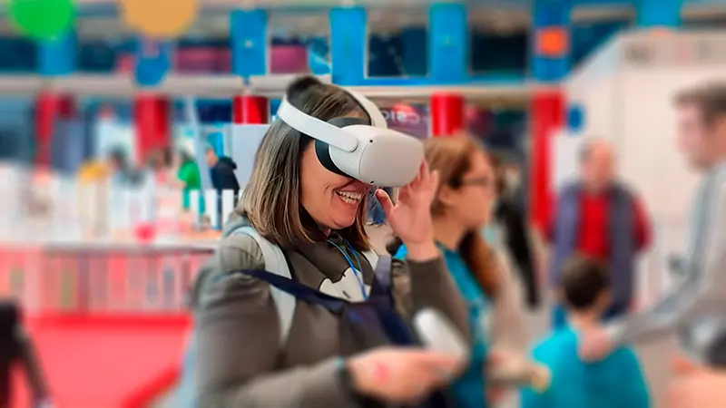 Fotografía de una mujer sonriente con gafas de realidad virtual puestas
